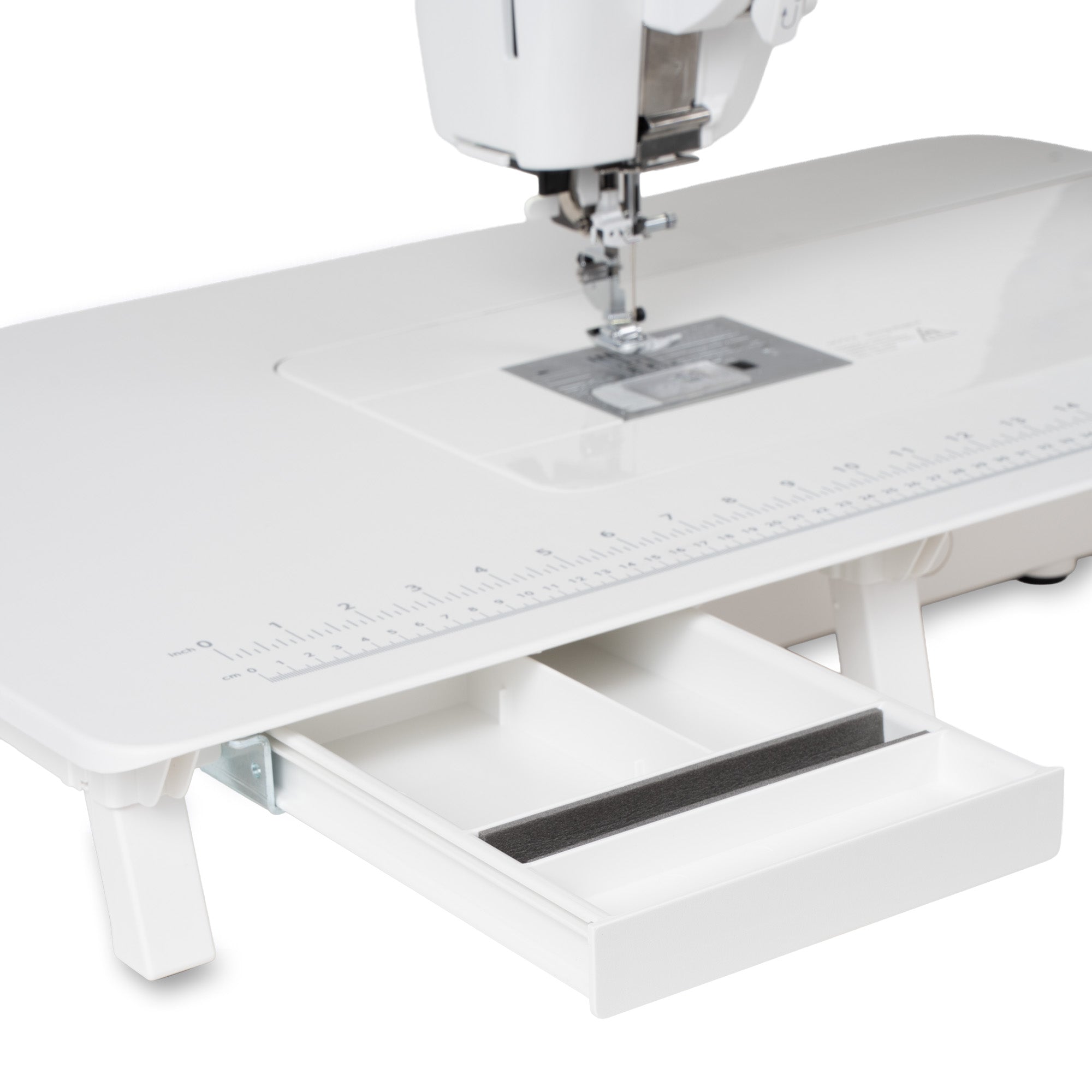 White sewing machine with an extended drawer underneath the table surface, shown on a clean white background.