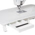 White sewing machine with an extended drawer underneath the table surface, shown on a clean white background.