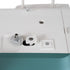 Close-up of the top surface of a white sewing machine, showing a button, metal screw, and a teal lower section.