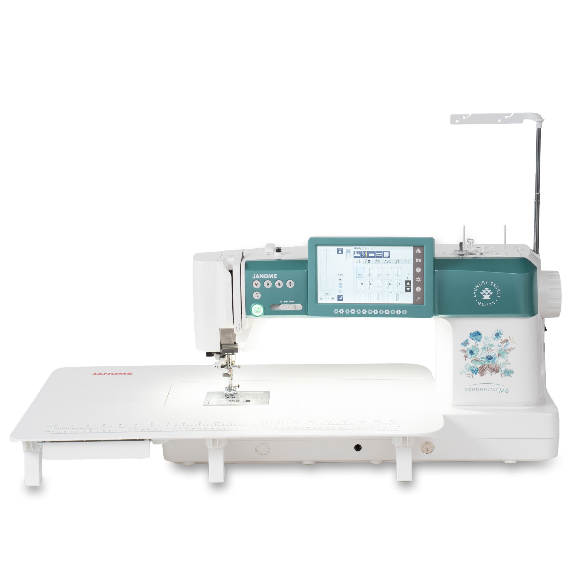 A Janome sewing machine with a long white extended table, a teal digital control panel, and a white body with a floral graphic on the side, shown against a plain white background.