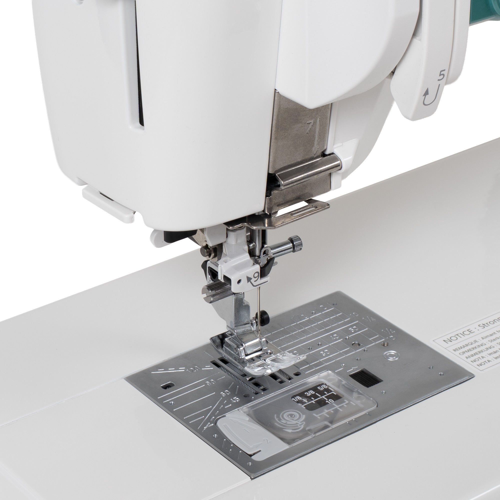 Close-up of a white sewing machine with a metallic presser foot and silver metal plate on a clean white background.