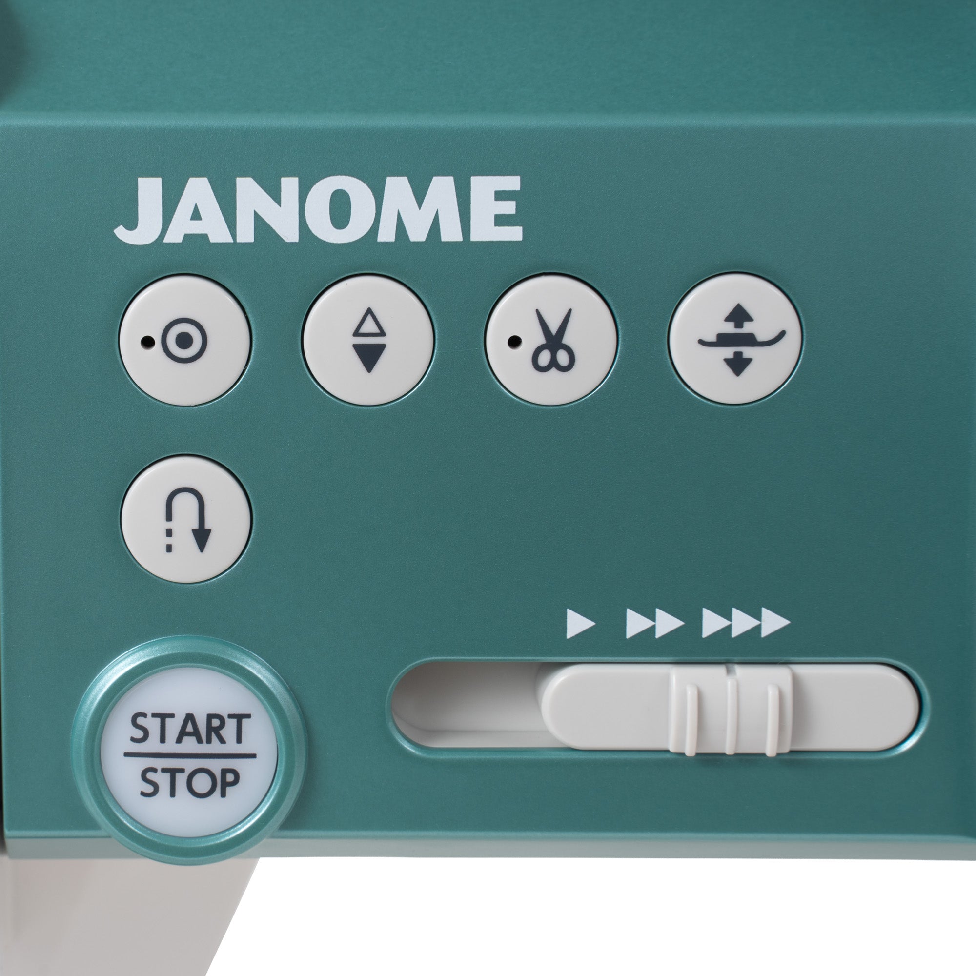 Close-up of a teal Janome sewing machine control panel with white buttons, including a start-stop button, directional arrows, and a speed slider.