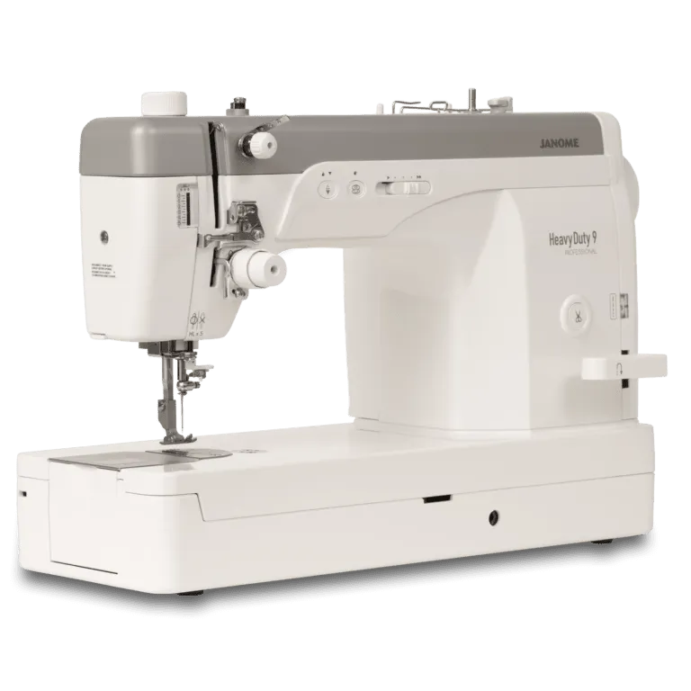 Janome Heavy Duty 9 sewing machine in white and gray, shown from a three-quarter angle on a clean white background.