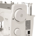 Close-up of a Janome Heavy Duty 9 sewing machine body in white, showing the large front dial, side vent, power switch, and part of the needle clamp area on a clean white background.
