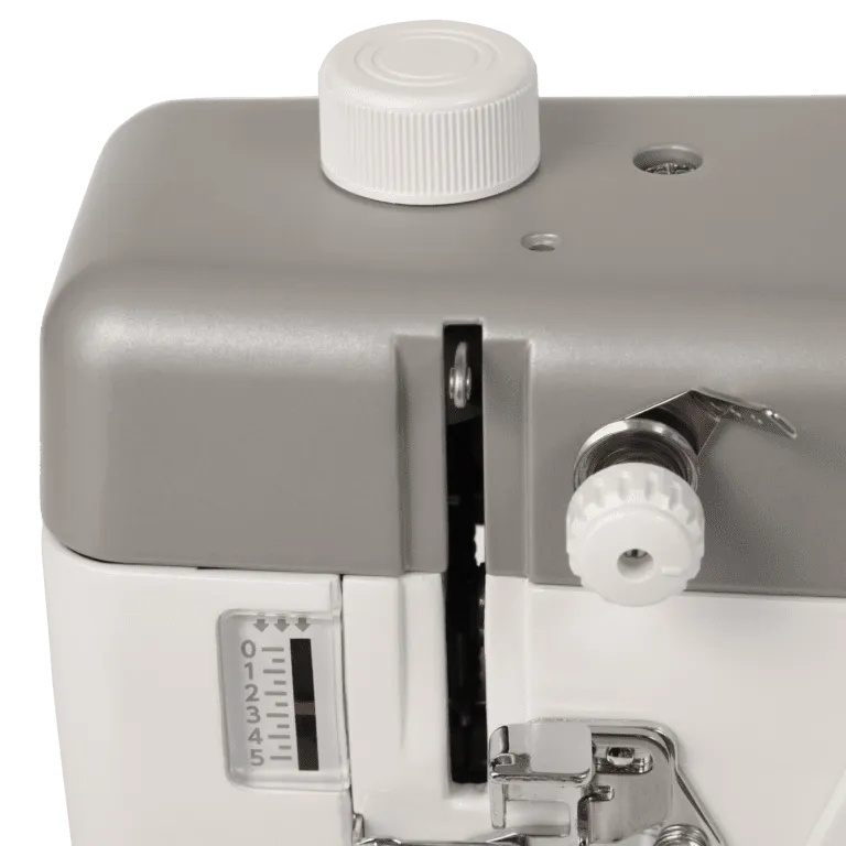 Close-up of a sewing machine showing the top cover, white cap, tension dial, and metal press foot on a white and gray machine body.