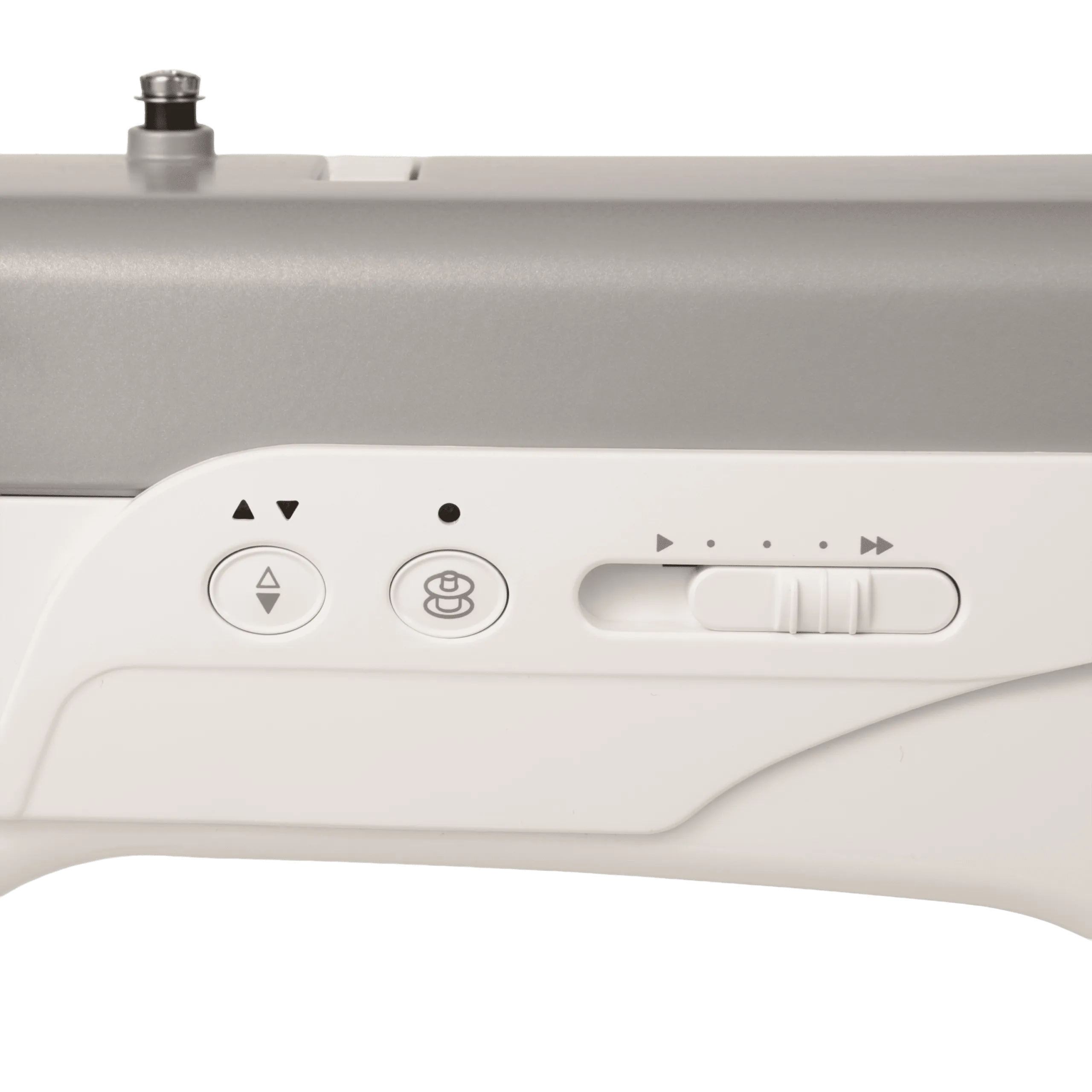 Close-up of a sewing machine control panel with buttons and a slide switch on a light gray and white machine body.