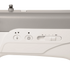 Close-up of a sewing machine control panel with buttons and a slide switch on a light gray and white machine body.