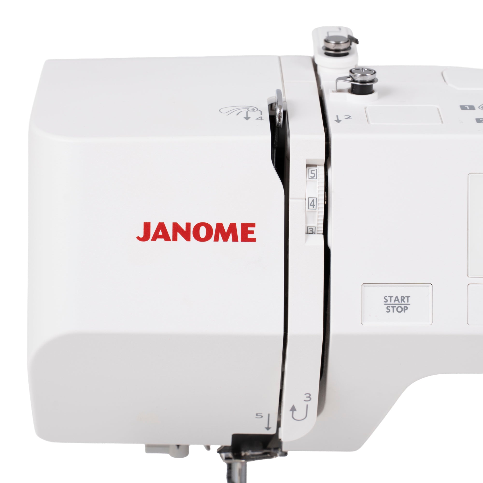 Close-up of a white Janome sewing machine showing the brand name in red, stitch selector dial, and part of the control panel on a white background.