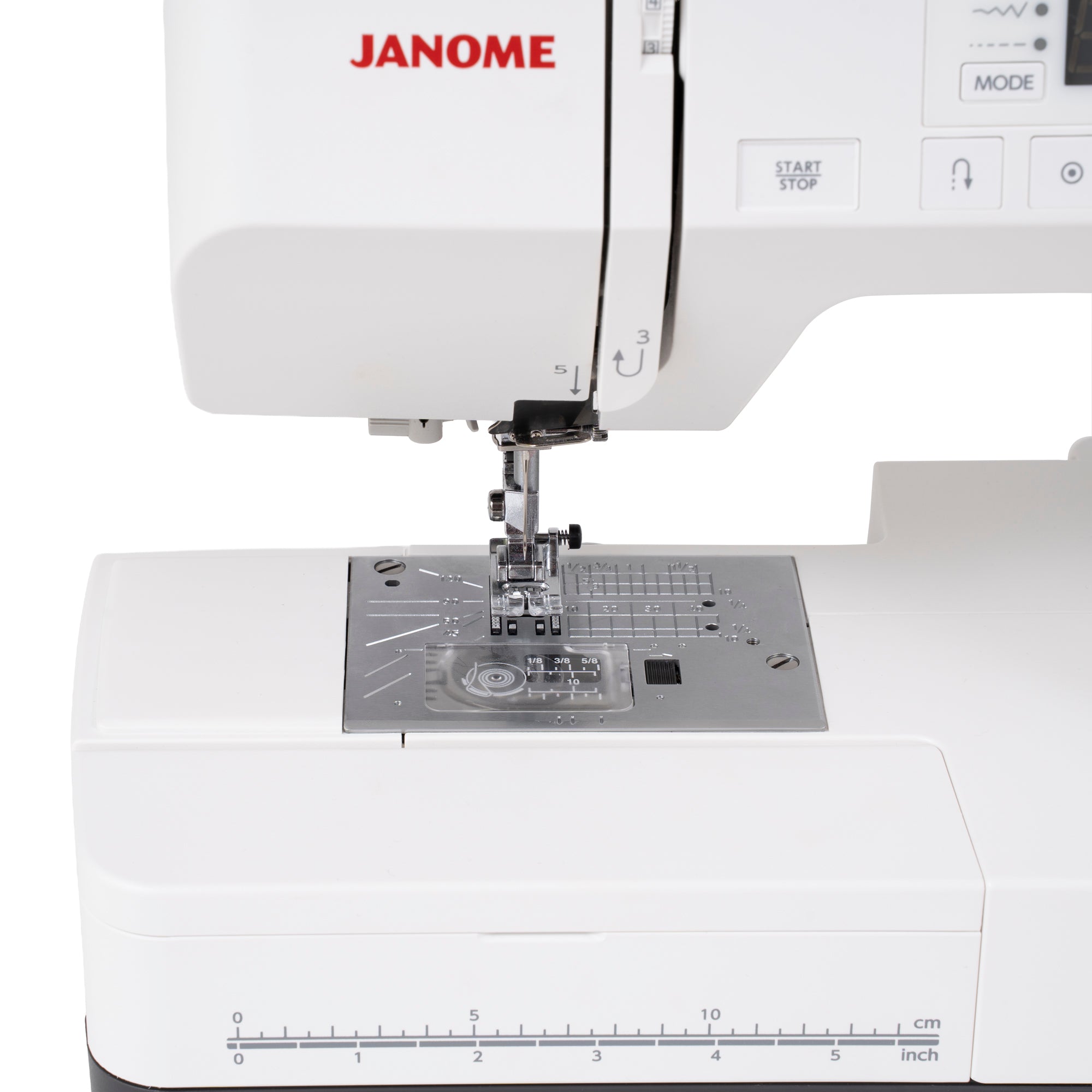 Close-up of a white Janome sewing machine showing the needle area, press foot, fabric guide, and part of the control panel on a clean white background.