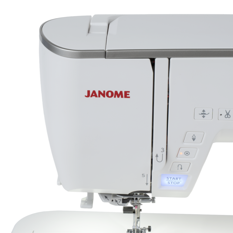 Close-up of a Janome sewing machine showing the upper housing, side control buttons, and part of the needle area on a clean white background.