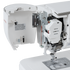 Close-up of a white sewing machine with the side cover open, showing internal mechanical components, wiring, and the needle plate area on a clean white background.