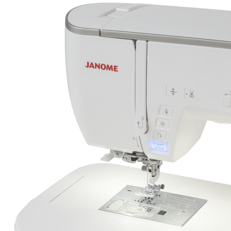 A close-up of a white Janome sewing machine showing the upper housing, control buttons, needle area, and part of the flatbed base against a clean white background.