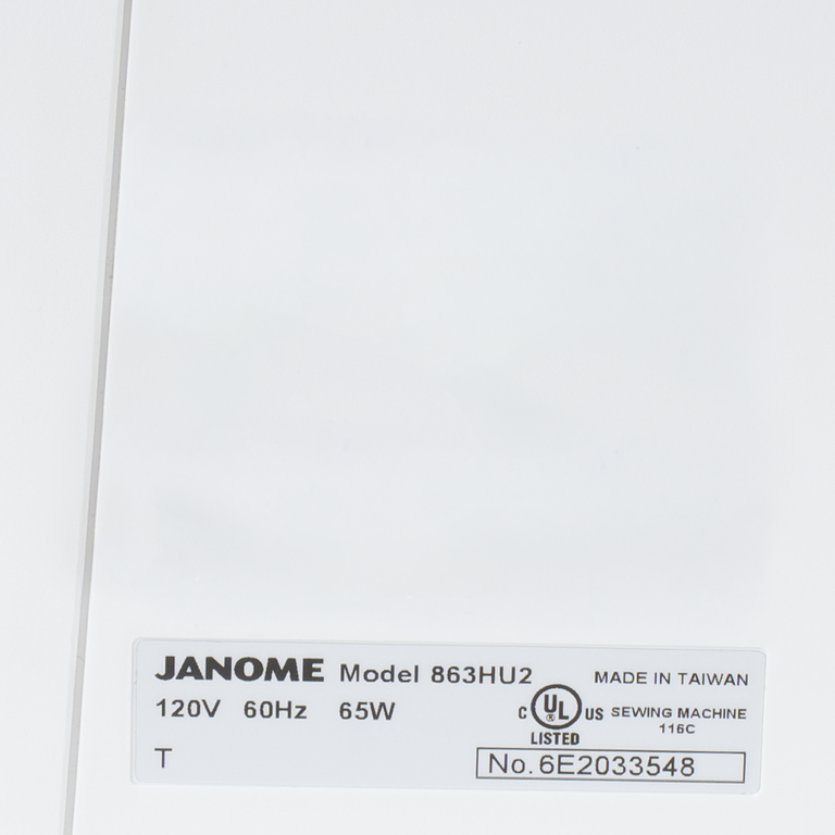 Close-up of a white Janome sewing machine label showing model 863HU2, 120V 60Hz 65W, made in Taiwan, with a UL listed mark.