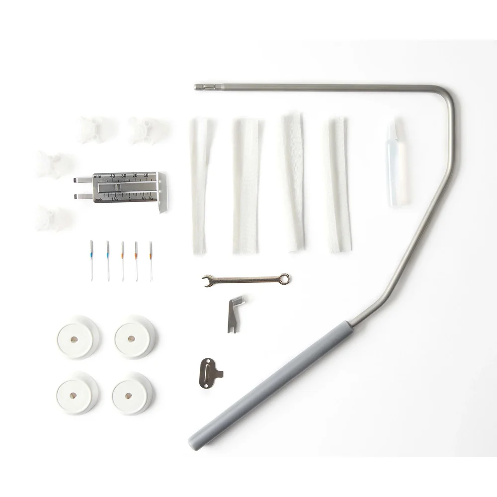 Set ofsewing machine accessories on a white background