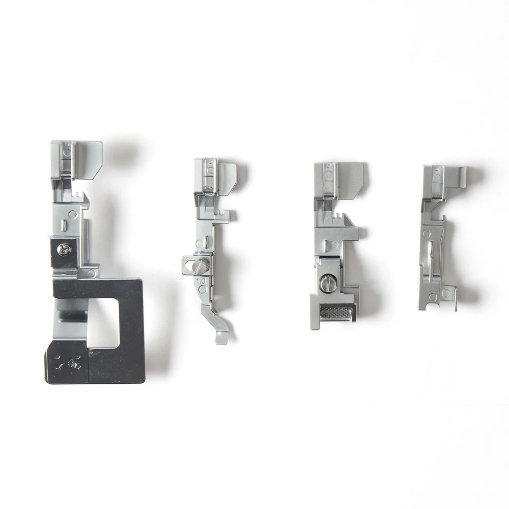 Set of four metal sewing machine presser feet on a white background