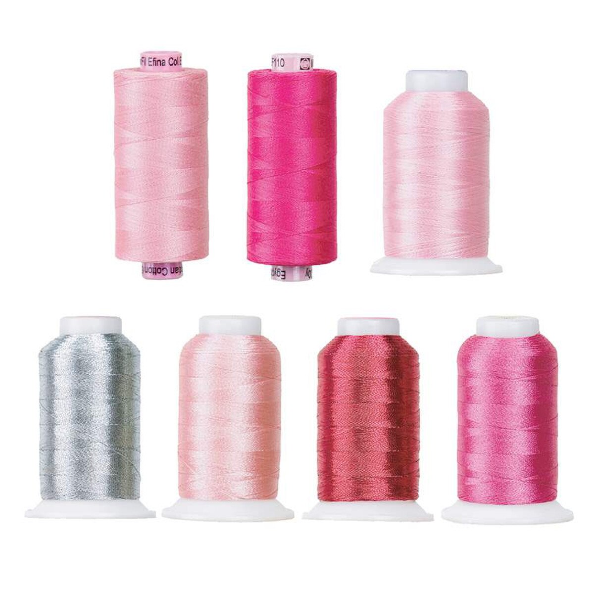 Set of eight spools of pink thread on a white background