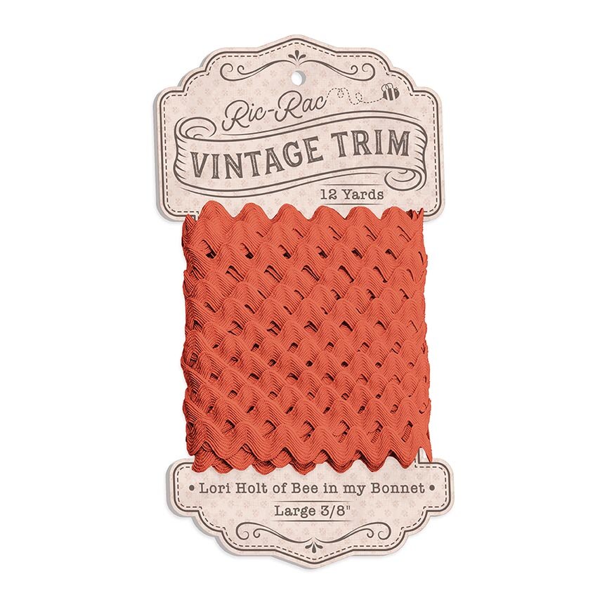 Packaged orange lace trim with 'Ric Rac Vintage Trim' label on a white background