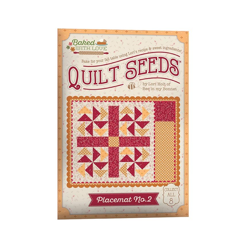Baked with Love Quilt Seeds Placemat No. 2 book cover, featuring a quilt pattern illustration in red, orange, and cream on a light background.