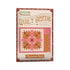 Baked with Love Quilt Seeds Placemat No. 5 kit packaging, featuring a quilt pattern illustration in pink, orange, and brown on a cream background with a red patterned border.