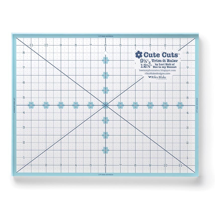 A square 9 1/4 inch trim-it ruler by Lori Holt, featuring a white grid with blue lines, measurement markings, and a central crosshair design, set against a clean white background.