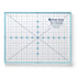 A square 9 1/4 inch trim-it ruler by Lori Holt, featuring a white grid with blue lines, measurement markings, and a central crosshair design, set against a clean white background.