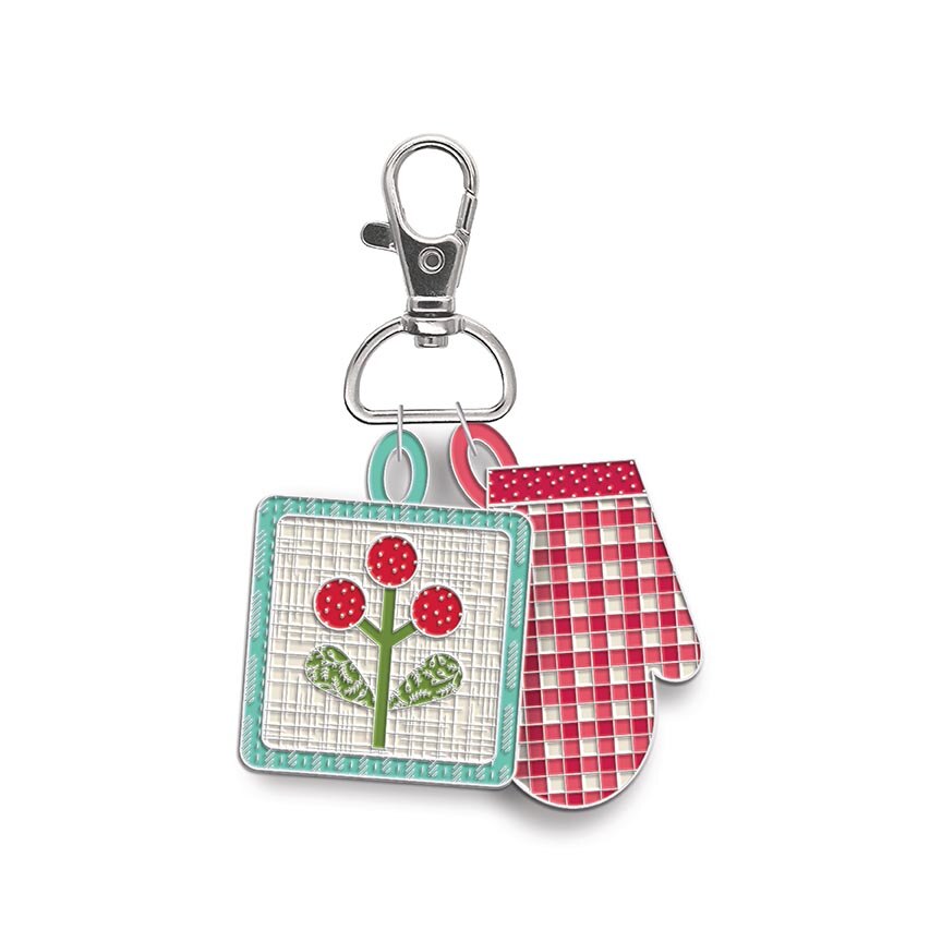 A kitchen accessory keychain featuring a square embroidered pot holder charm with red flowers and a red-and-white gingham oven mitt, attached to a silver lobster clasp on a white background.