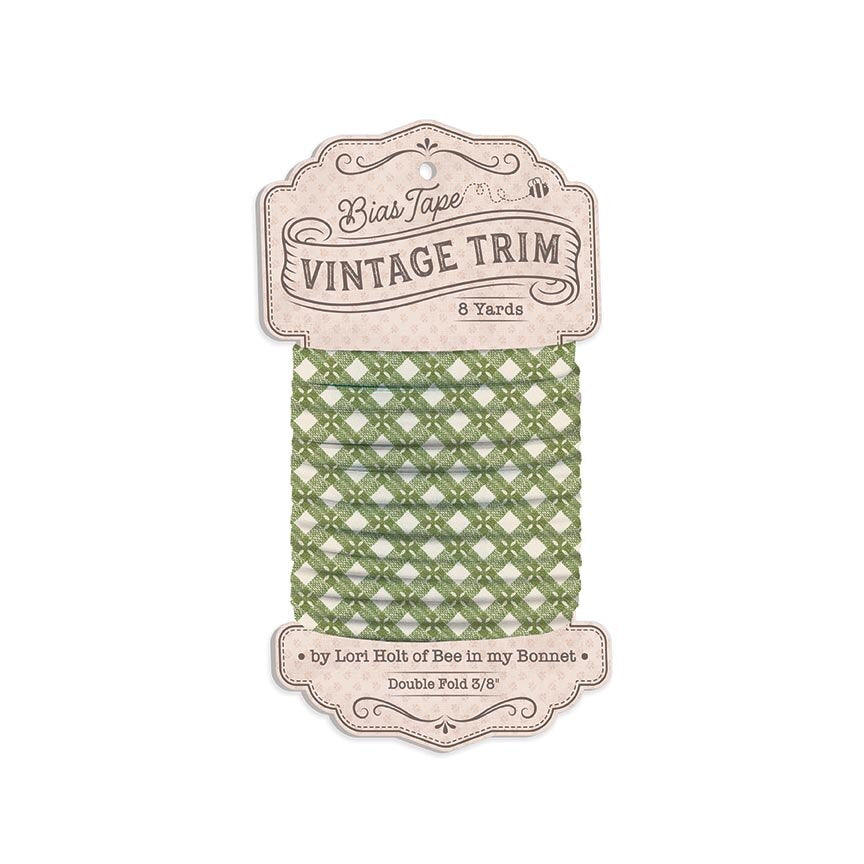 A package of Bias Tape Vintage Trim in sage green, featuring a spool of double-folded 3/8 inch tape with a decorative paper header card.