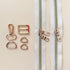 Gold zippers and hardware on a beige background