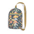 A small crossbody bag with a navy blue background and a colorful floral and patchwork-style print, featuring a tan adjustable shoulder strap and a front zip pocket.
