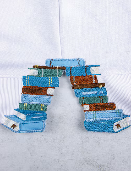 Decorative letter 'P' made of books on a white background