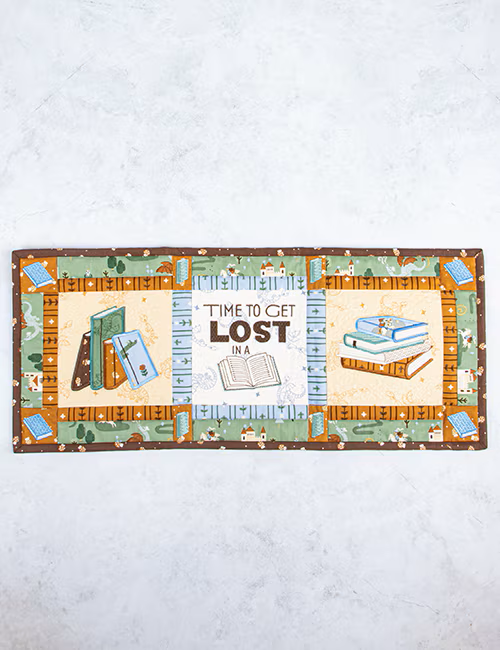 Decorative mat with book-themed illustrations and text on a white background