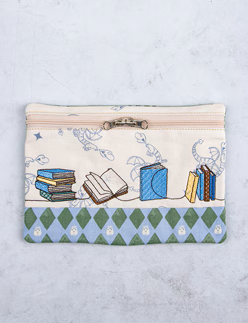 Fabric pouch with book illustration on a light gray background