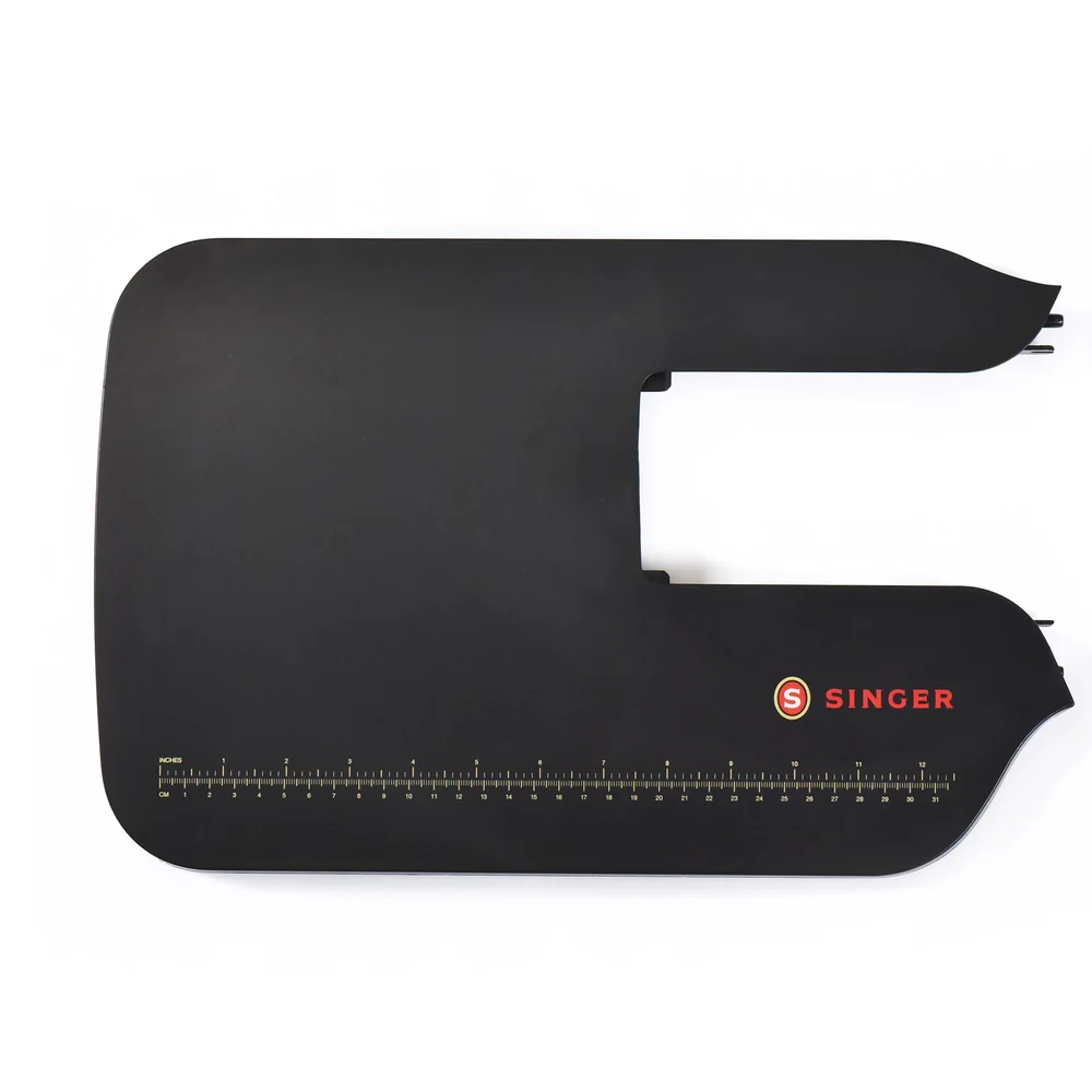 Black Singer sewing machine extension table with a red logo and a printed measurement scale along the bottom edge, shown on a white background.