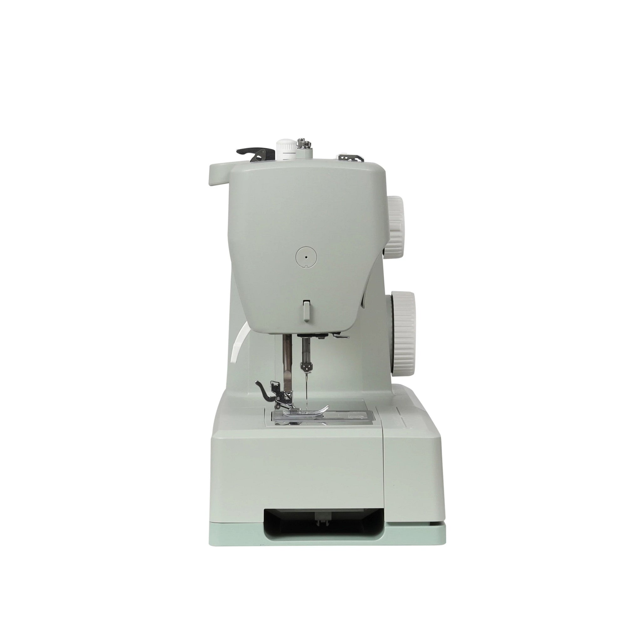 A compact, light sage green sewing machine with white dials, shown from a front-facing perspective on a solid white background.