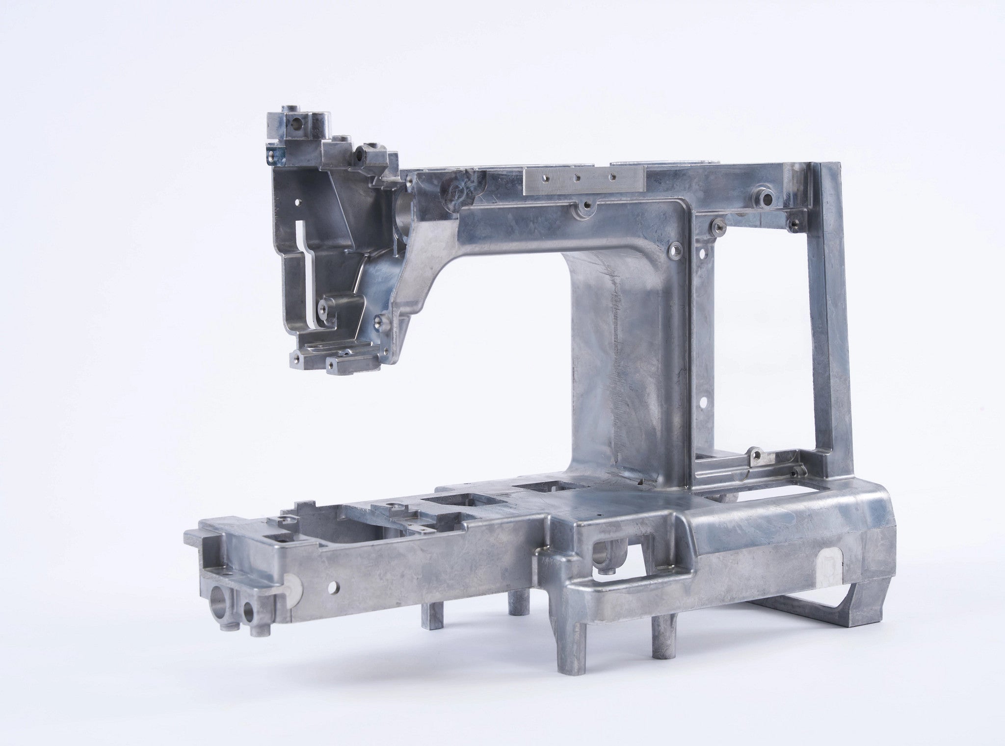 A metallicsewing machine frame component, likely made of cast aluminum, shown on a seamless white studio background.