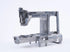A metallic sewing machine frame component, made of cast aluminum, shown on a seamless white studio background.