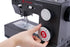 A close-up of a black Singer Heavy Duty sewing machine with a person's hand adjusting a white and black speed control dial. The brand name 'SINGER' and 'Heavy Duty' are printed on the machine in red and white.