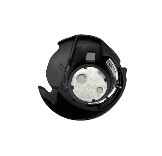 A black plastic sewing machine bobbin case with a silver metal center plate, isolated on a white background.
