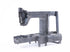 A dark gray cast metal sewing machine frame, photographed on a seamless white background.