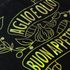 Holographic foil design with garlic and olive oil text on a black background