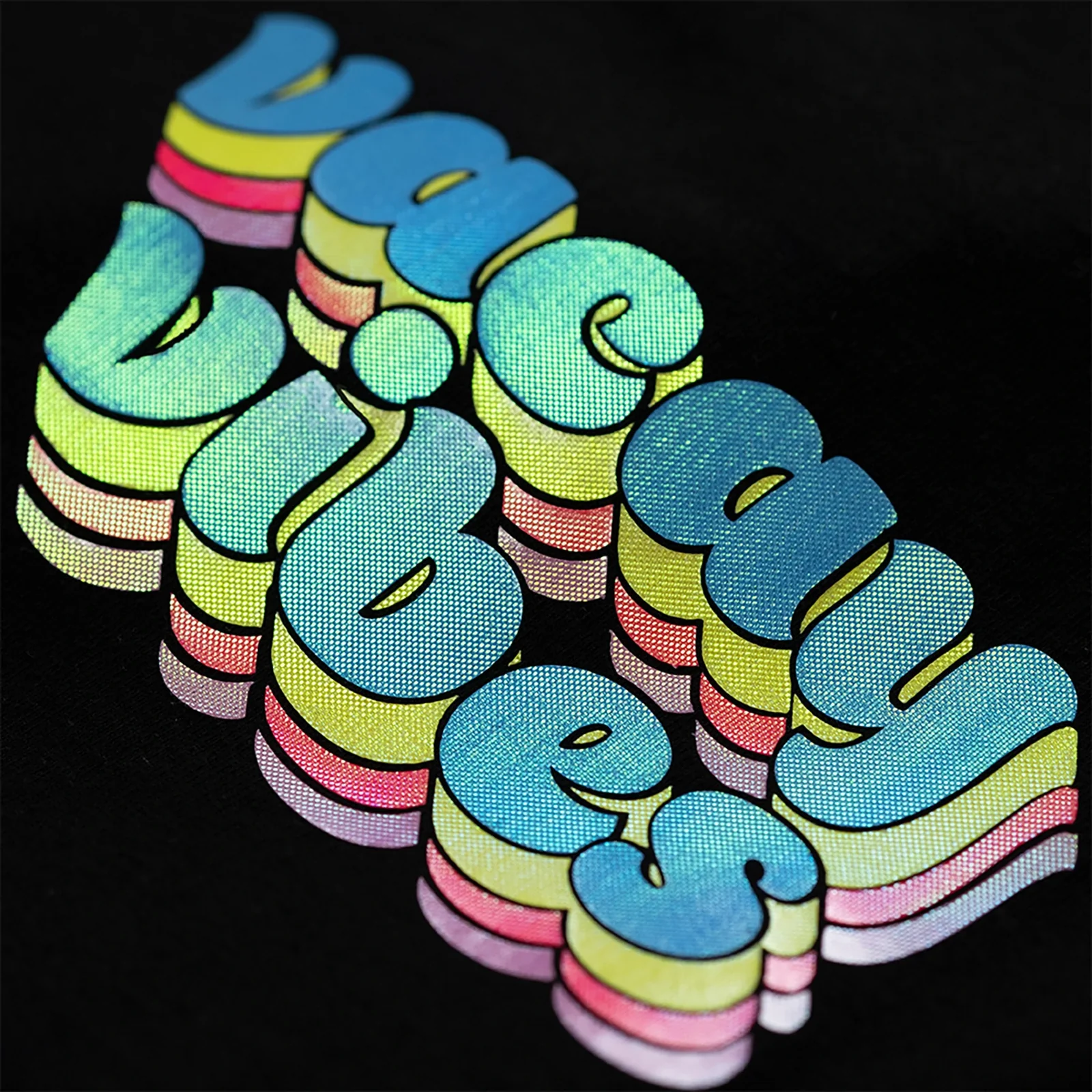 Colorful vinyl patch with 'Vacay Vibes' text on a black background