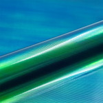 Close-up of green and blue gradient vinyl roll with texture against a blue background