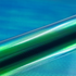 Close-up of green and blue gradient vinyl roll with texture against a blue background