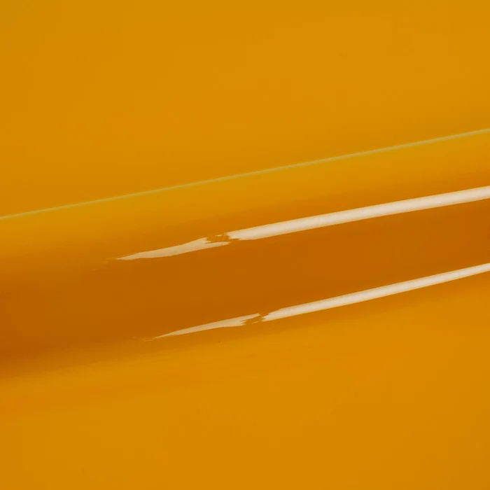 Close-up of yellow vinyl wrap with a glossy finish