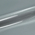 Close-up of a roll of silver reflective vinyl wrap on a gray background