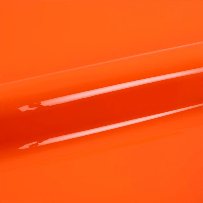 Close-up of bright orange vinyl wrap with a glossy finish