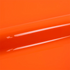 Close-up of bright orange vinyl wrap with a glossy finish