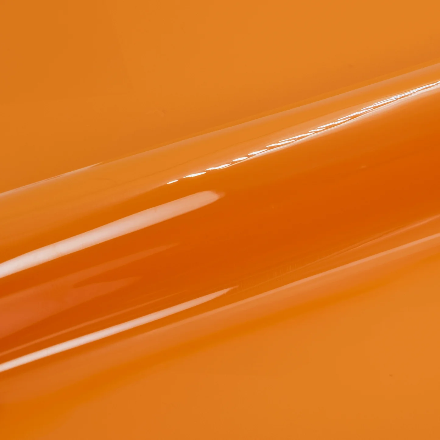Close-up of a glossy orange vinyl roll