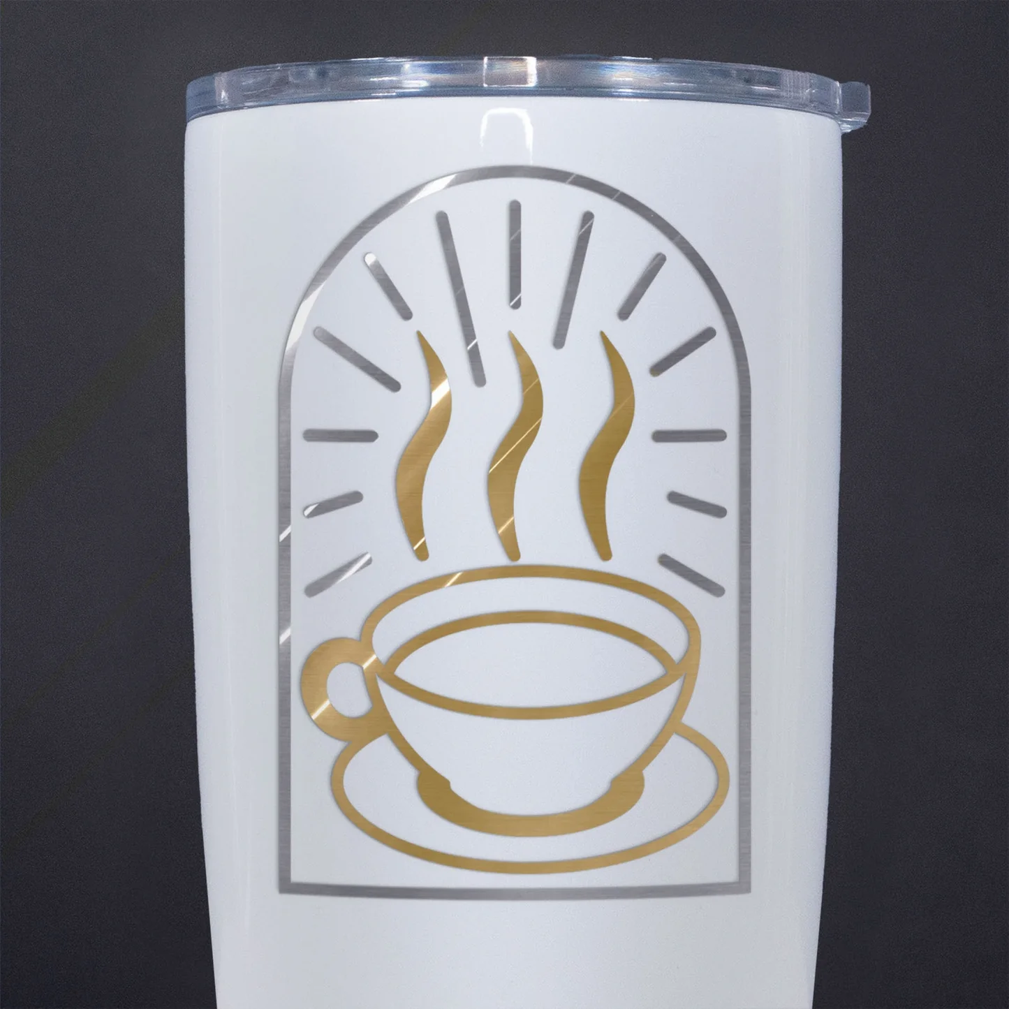 White tumbler with gold coffee cup design on a black background