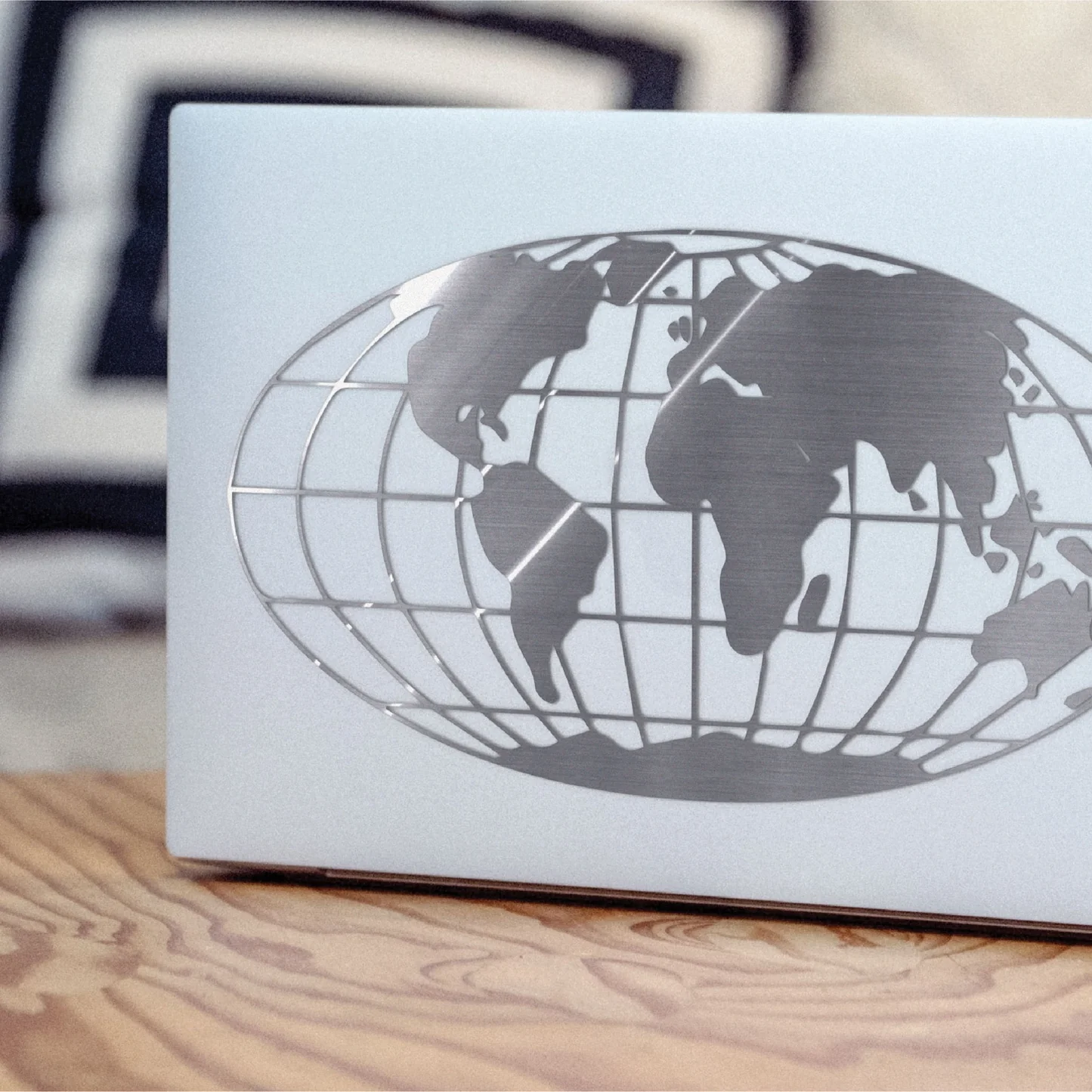 White box with a black globe design on a wooden surface